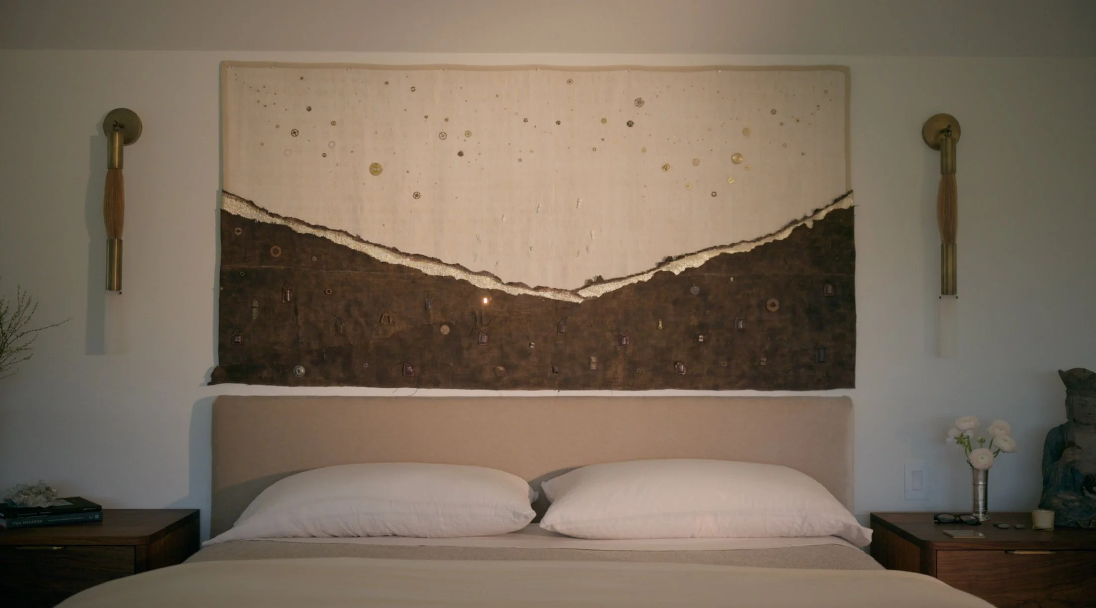 Landscape of Blessings for Laura, installed above a bed between two wall sconces.