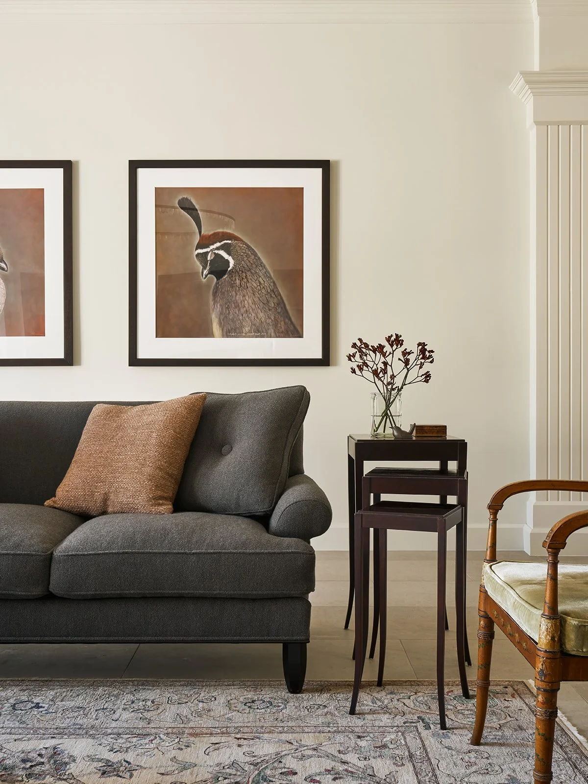 Living room featuring a vintage reupholstered Baker sofa, antique side table, classic accent chair, and large quail photographs by Kate Breakey in a palette inspired by nature.
